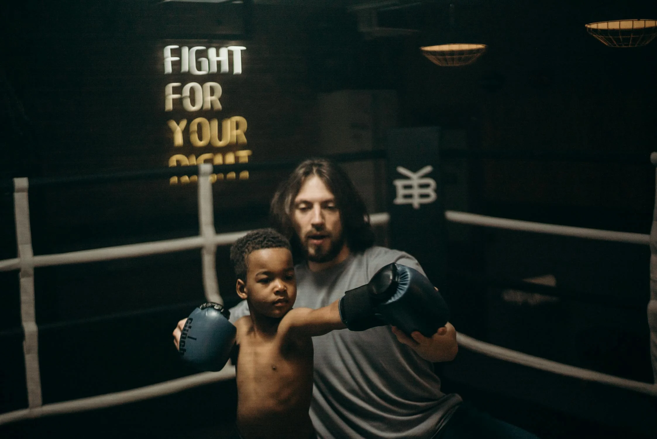 Young boy being trained to box